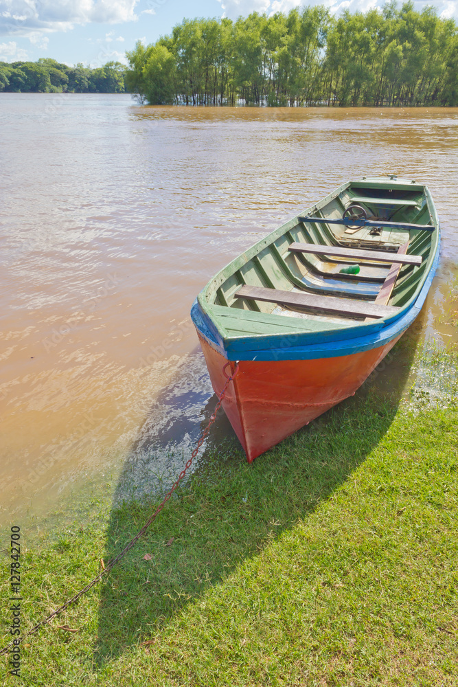 Wood boat during a flood at Rio Pardo river Wood boat during a flood at Rio Pardo river