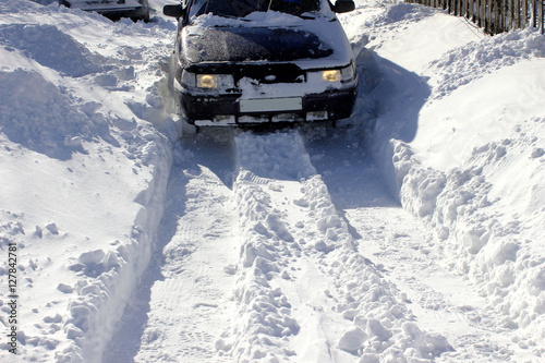 Deep drifts of snow. after a heavy snowfall. A vehicle stuck in the snow. ©  AKA-RA