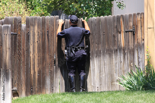 policeman looking over fence