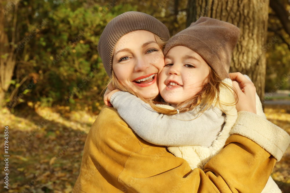 Mother and daughter hugging in beautiful autumn park Mother and daughter hugging in beautiful autumn park