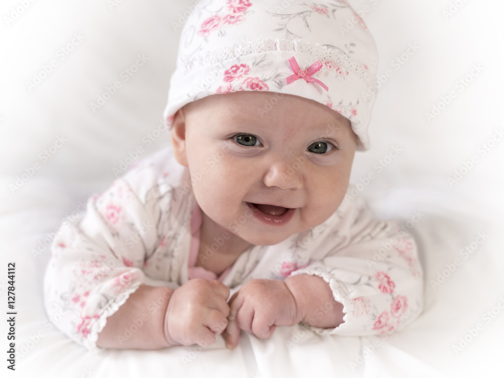 Adorable Newborn Baby Girl Wearing Pink Flower Outfit in Close Up Face Shot Adorable Newborn Baby Girl Wearing Pink Flower Outfit in Close Up Face Shot