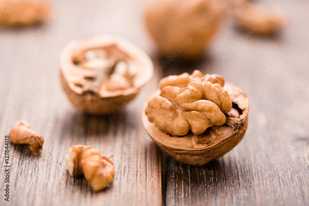 Walnuts on wooden table. Macro. Front view