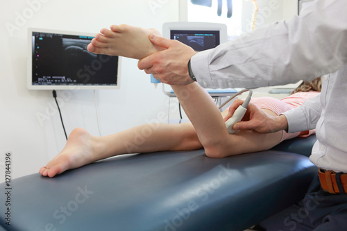 Ultrasound of girl's knee-joint - diagnosis photo