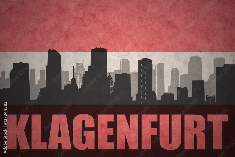 abstract silhouette of the city with text Klagenfurt at the vintage austrian flag