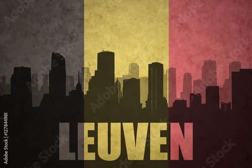 abstract silhouette of the city with text Leuven at the vintage belgian flag