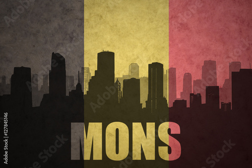 abstract silhouette of the city with text Mons at the vintage belgian flag