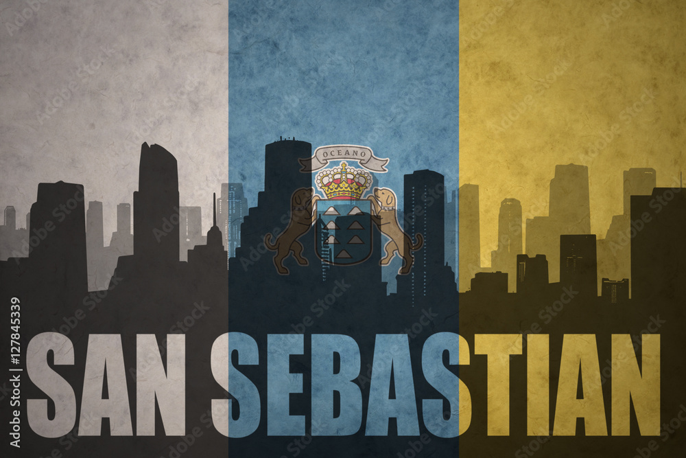 abstract silhouette of the city with text San Sebastian at the vintage canary islands flag