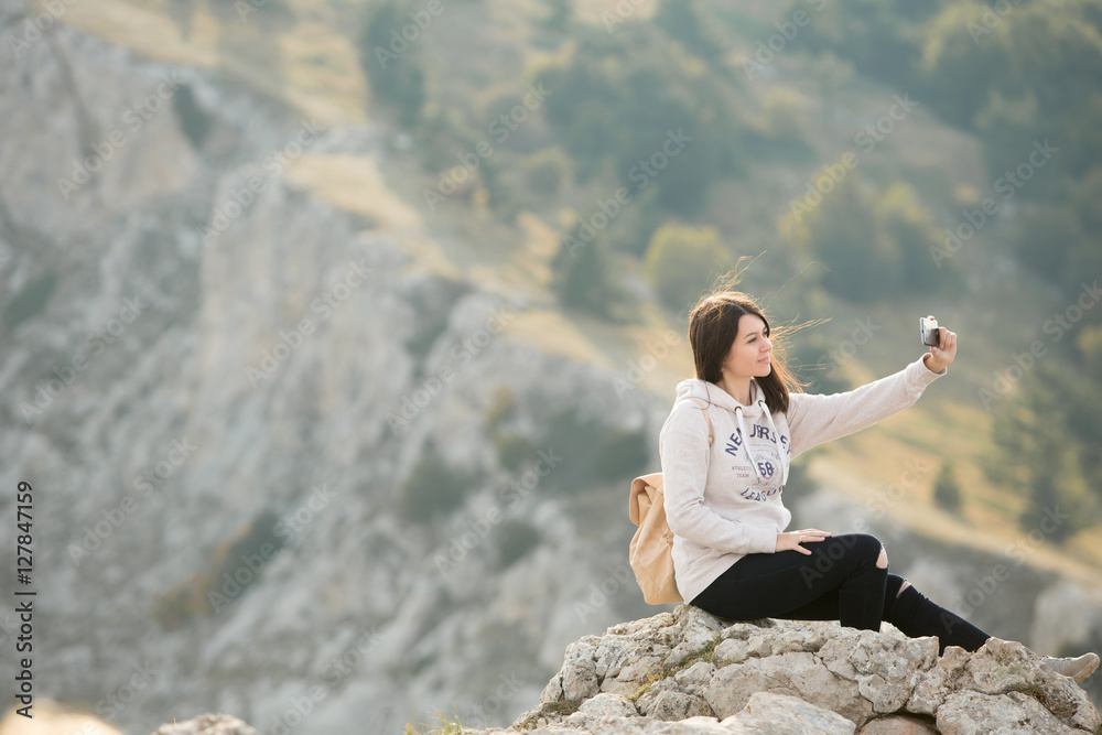 woman hiker use digital tablet taking photo at mountain peak cli