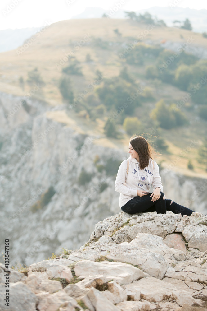 woman with backpack standing on a rock woman with backpack standing on a rock