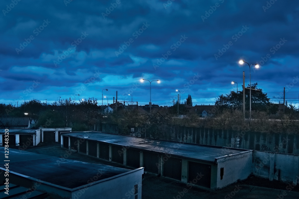 Chomutov, Ustecky kraj, Czech republic - November 17, 2016: dark blue sky above the garages and road number 13 during the upcoming evening