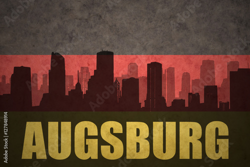 abstract silhouette of the city with text Augsburg at the vintage german flag