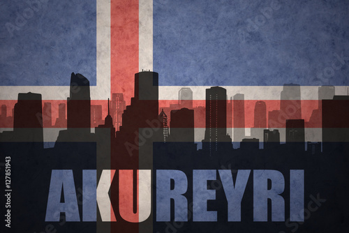 abstract silhouette of the city with text Akureyri at the vintage icelandic flag photo