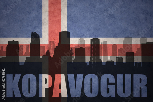 abstract silhouette of the city with text Kopavogur at the vintage icelandic flag photo