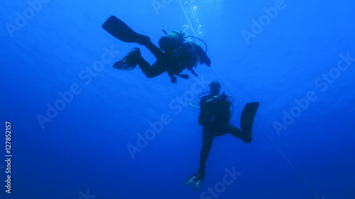 Silhouette scuba diving. © lutya