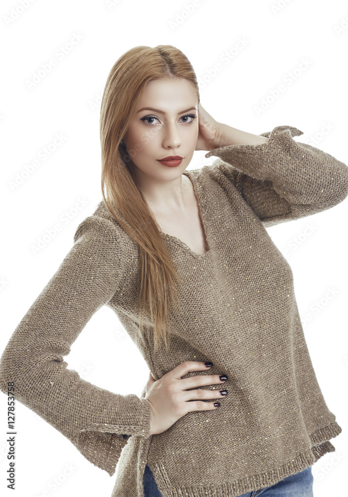 Attractive sensual young woman wearing warm homemade knitted pullover.  Gorgeous flirtatious female fashion model in winter woolen sweater posing  with hand on hip against white background. Stock Photo | Adobe Stock
