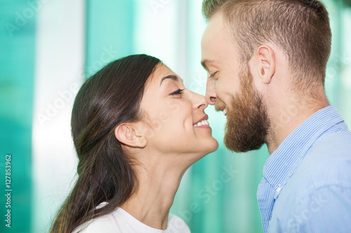 Portrait of lovely young couple rubbing noses photo