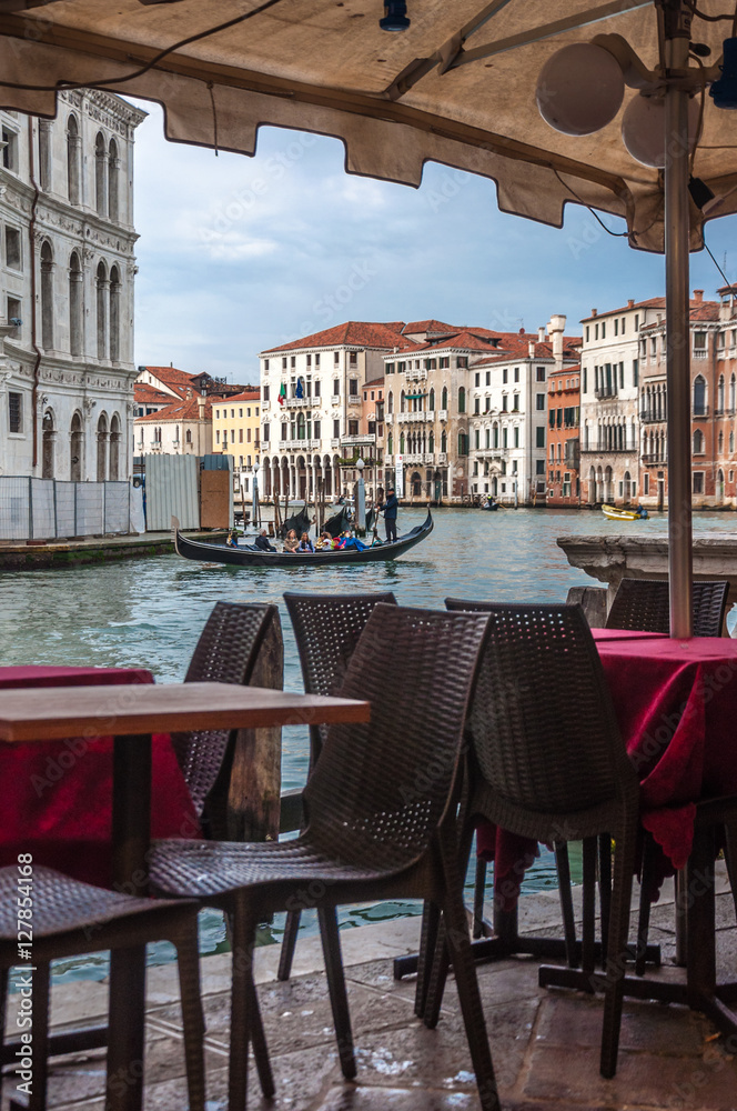 Restaurant's tables near the Canal Grande in Venice, Italy. 