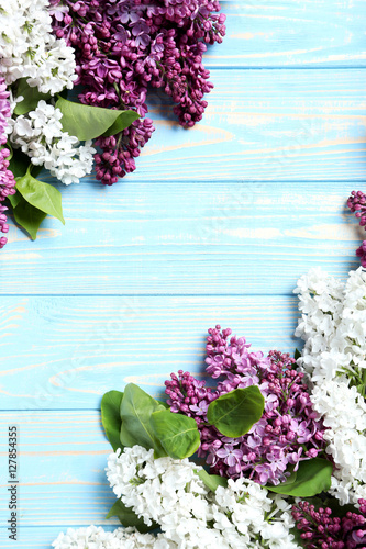 Fototapeta Naklejka Na Ścianę i Meble -  Blooming lilac flowers on a blue wooden table