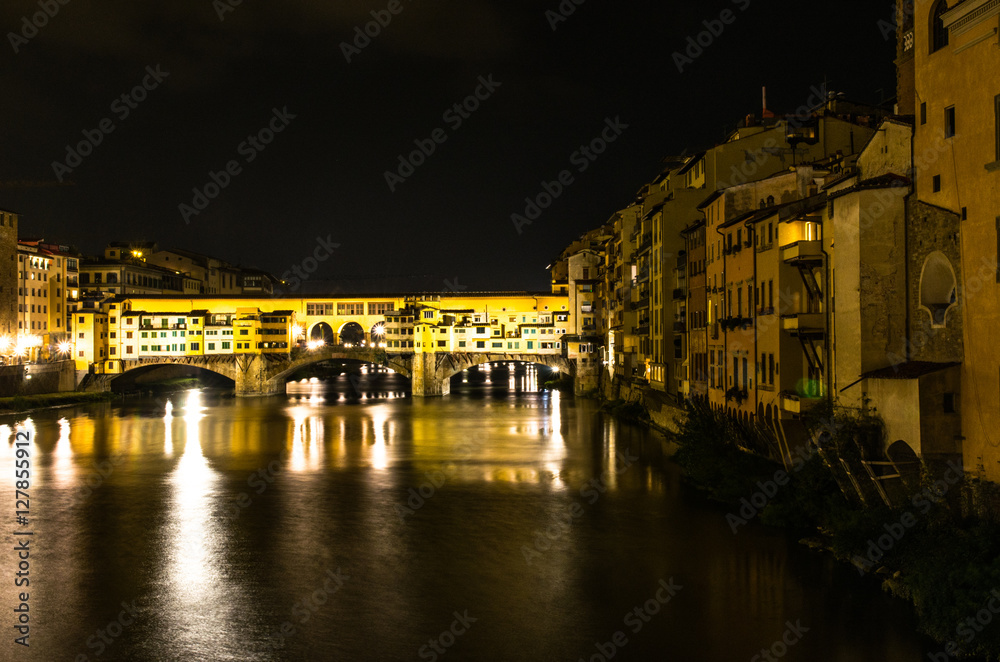 Light reflection on the Arno Rive and Ponte Vecchio bridge by night, Florence