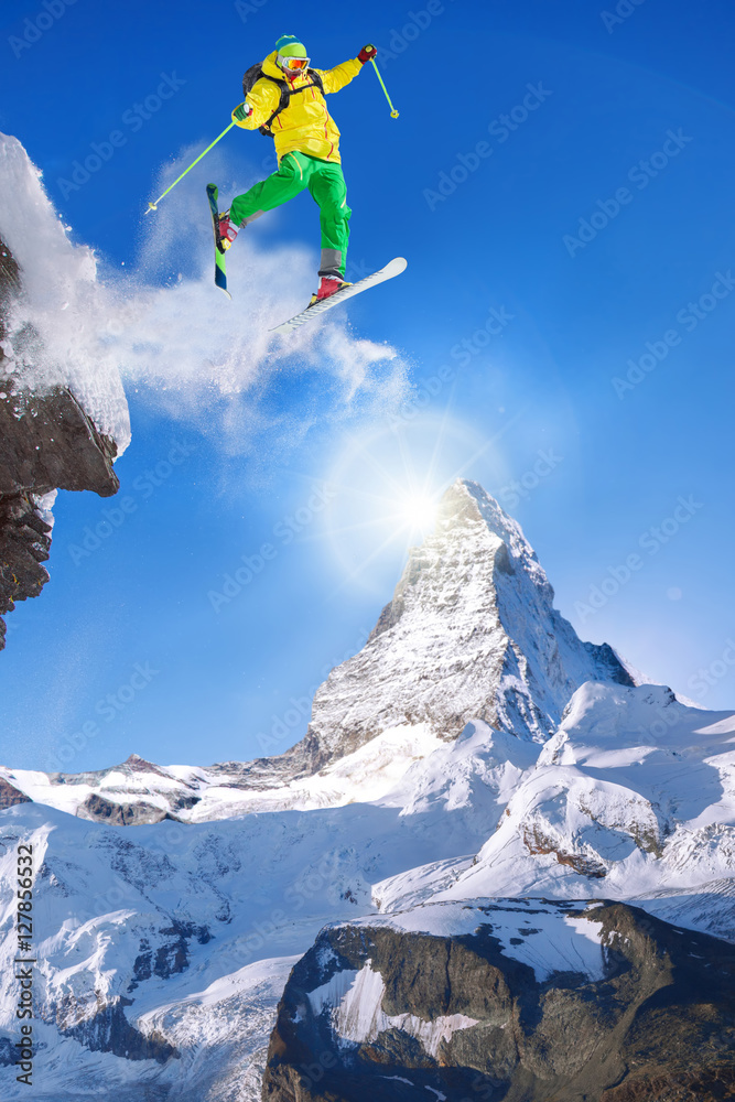 Skier jumping against Matterhorn peak in Switzerland.