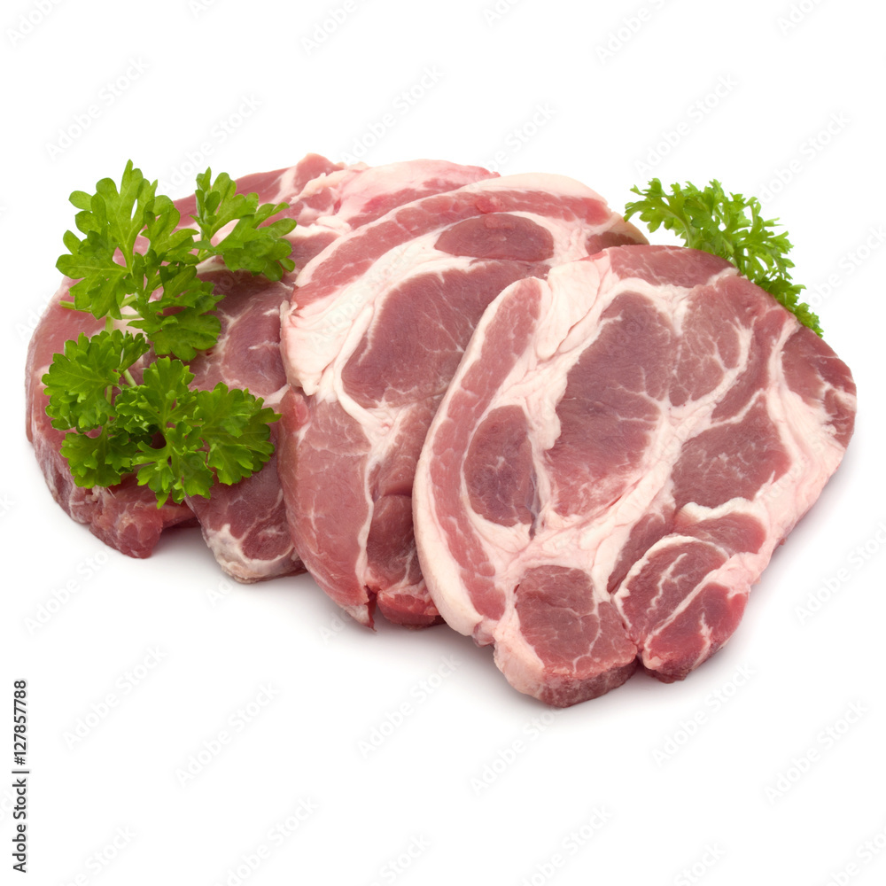 Raw pork neck chop meat with parsley herb leaves garnish isolate Raw pork neck chop meat with parsley herb leaves garnish isolate