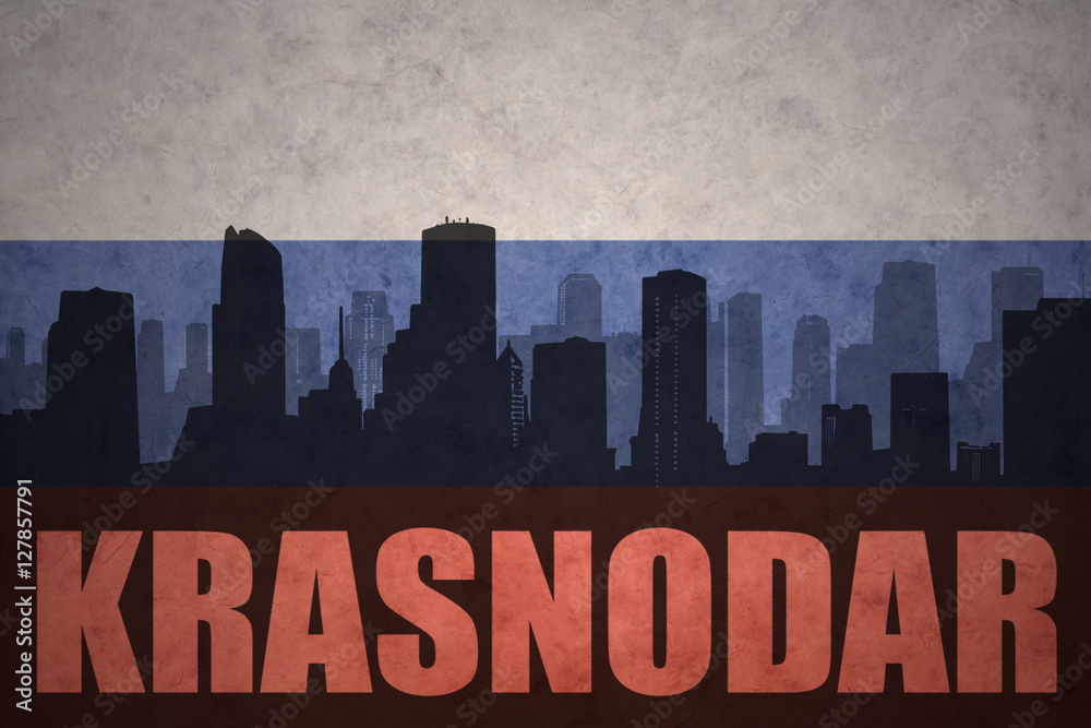 abstract silhouette of the city with text Krasnodar at the vintage russian flag