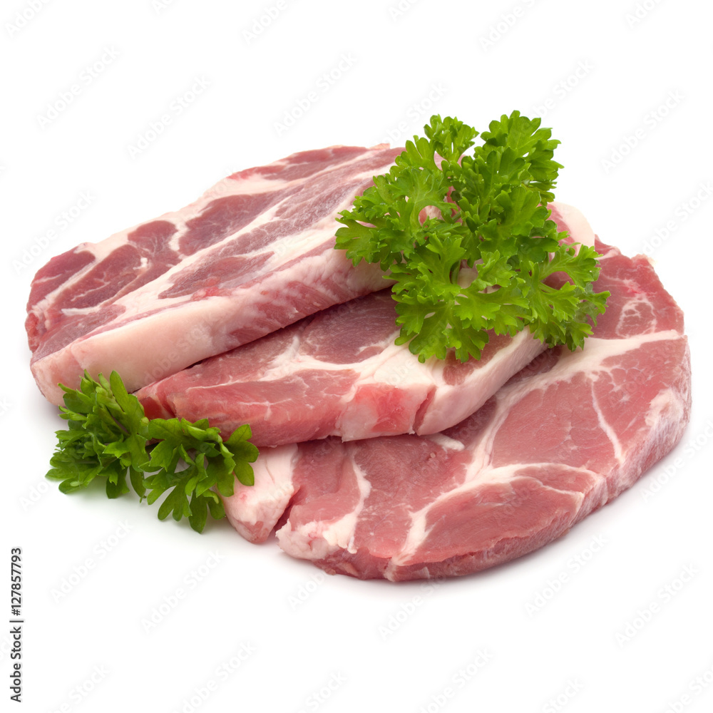 Raw pork neck chop meat with parsley herb leaves garnish isolate Raw pork neck chop meat with parsley herb leaves garnish isolate