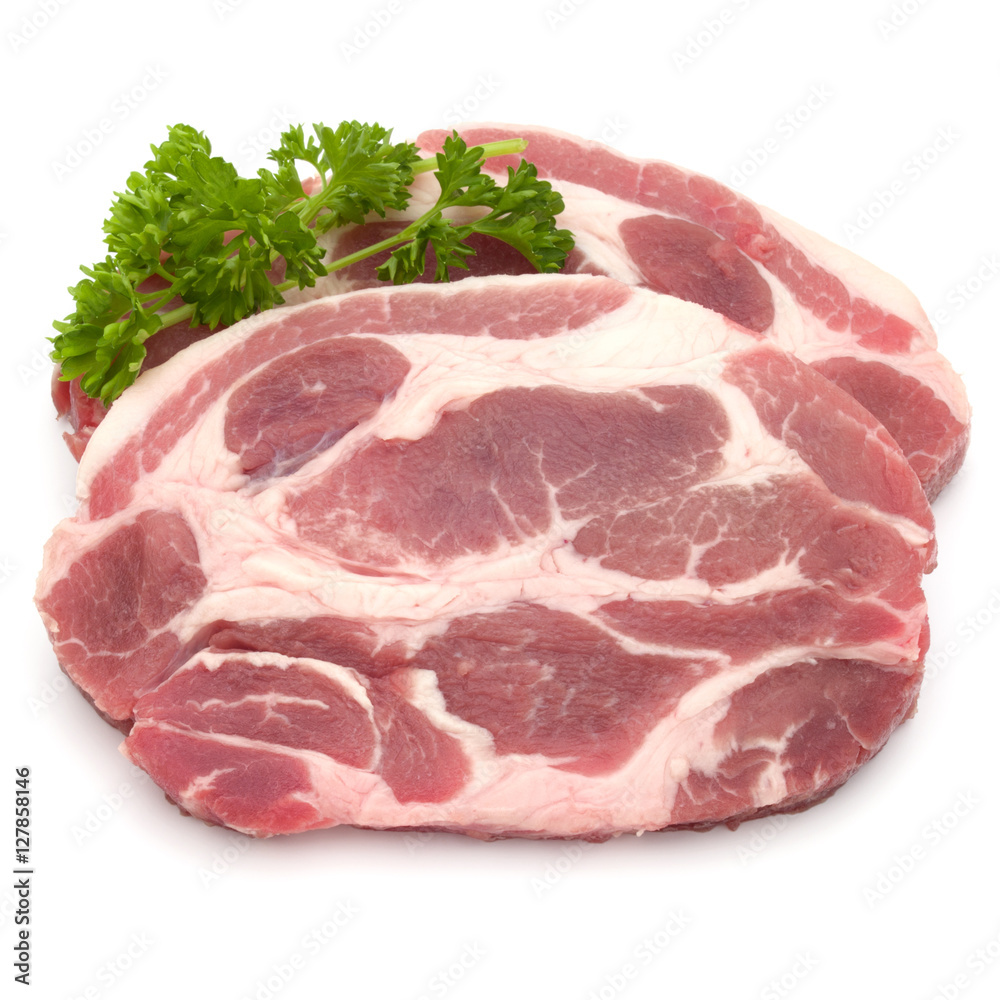 Raw pork neck chop meat with parsley herb leaves garnish isolate Raw pork neck chop meat with parsley herb leaves garnish isolate