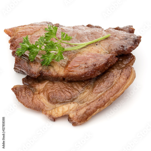 Cooked fried pork meat with parsley herb leaves garnish isolated