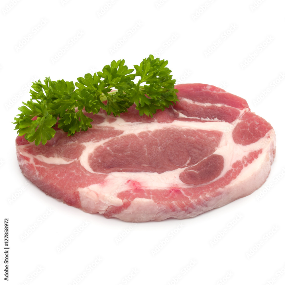 Raw pork neck chop meat with parsley herb leaves garnish isolate Raw pork neck chop meat with parsley herb leaves garnish isolate