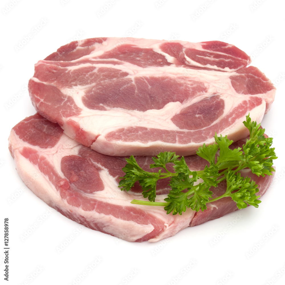 Raw pork neck chop meat with parsley herb leaves garnish isolate Raw pork neck chop meat with parsley herb leaves garnish isolate