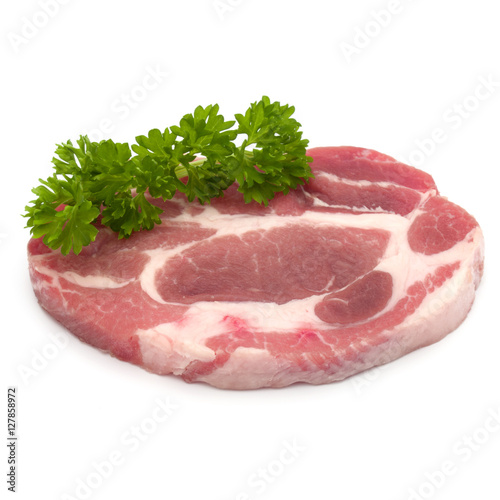 Raw pork neck chop meat with parsley herb leaves garnish isolate