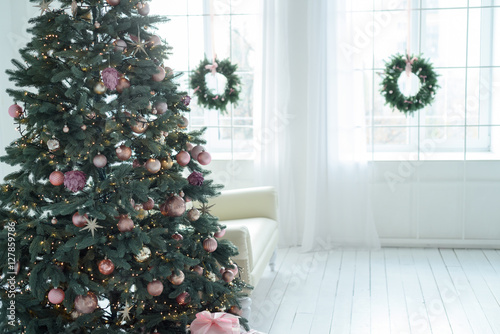 Christmas decorations with christmas tree and gifts in white living room