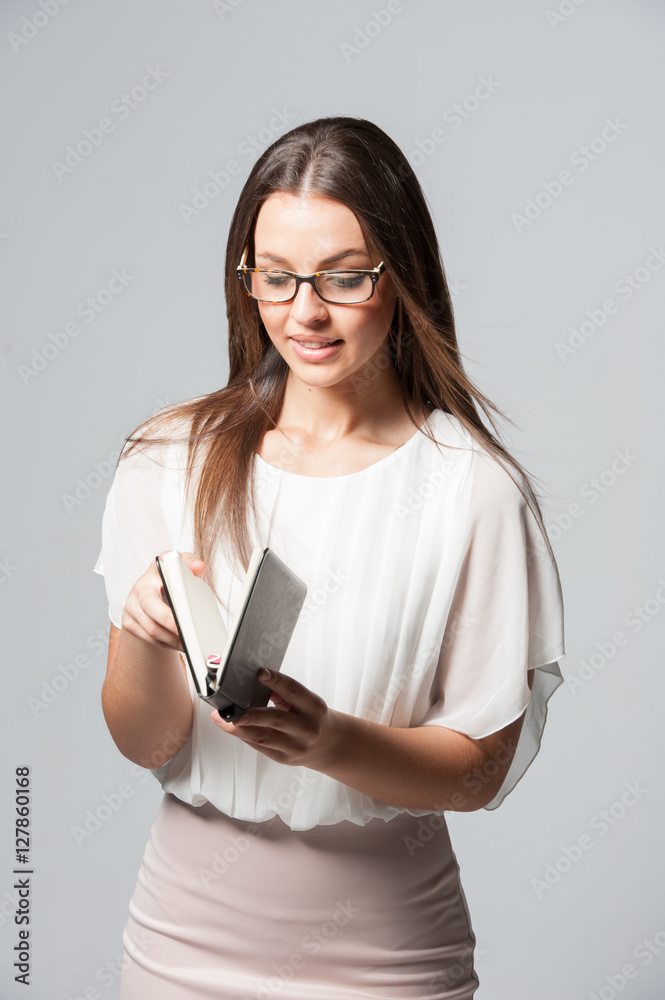 Portrait of smiling young business woman holding a diary Portrait of smiling young business woman holding a diary