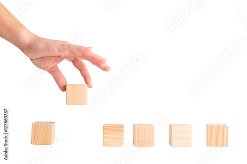 wooden blocks on a white background. Cube in hand