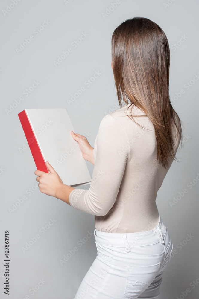 Portrait of smiling young business woman holding a folder Portrait of smiling young business woman holding a folder