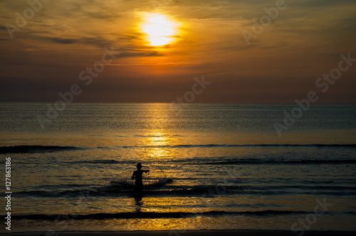 Fisherman casting a net at dawn © Robert Clay