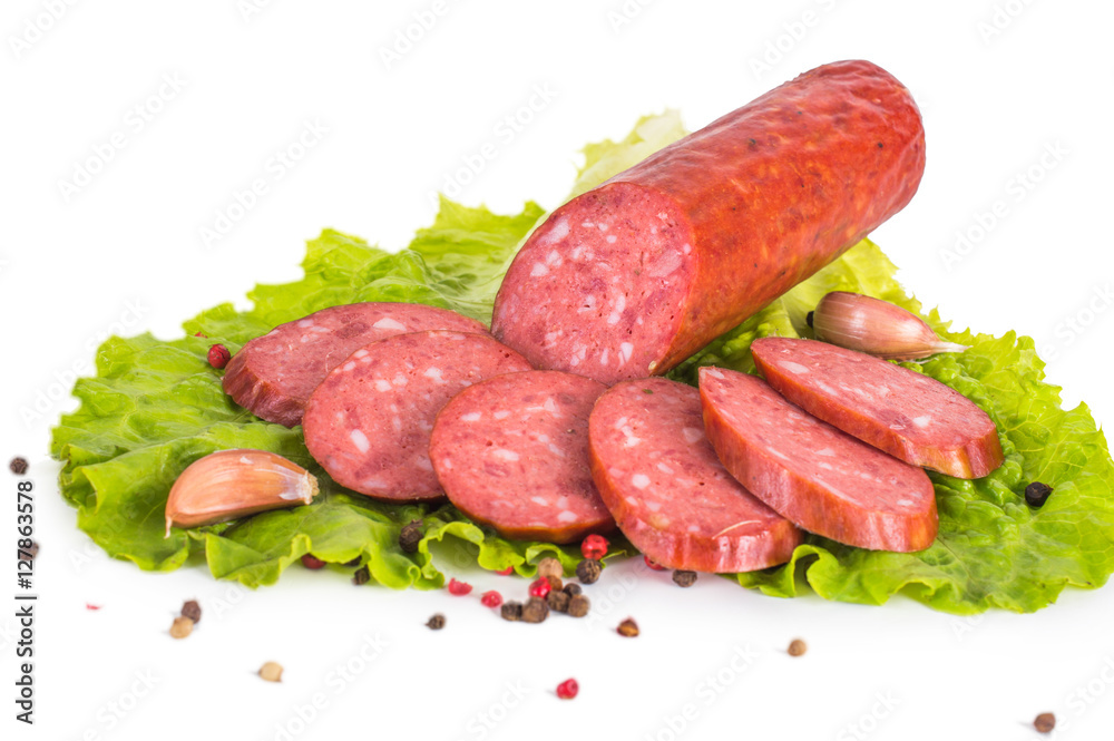 Salami with lettuce, pepper and garlic on a white background