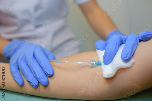 Closeup of intravenous drip in arm photo