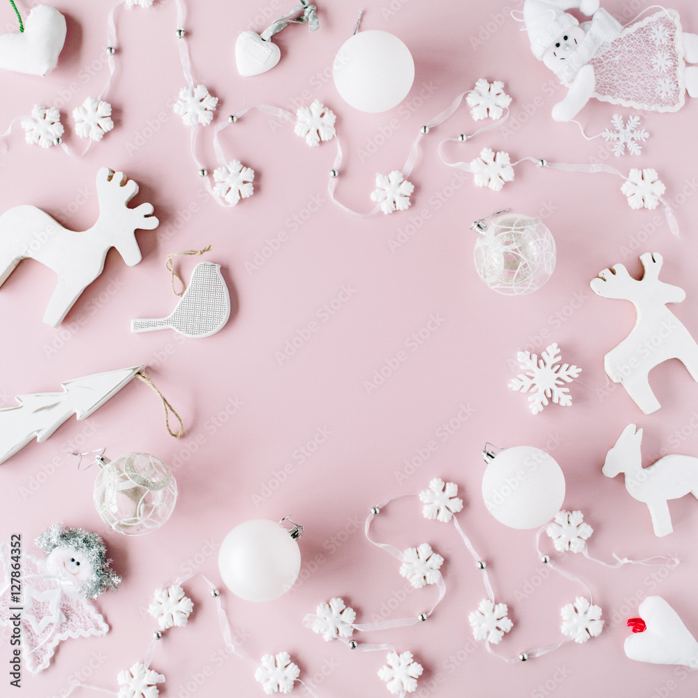 frame made of white christmas decoration with christmas glass balls, tinsel, bow, elk, bird on pink background. christmas wallpaper. flat lay, top view frame made of white christmas decoration with christmas glass balls, tinsel, bow, elk, bird on pink background. christmas wallpaper. flat lay, top view
