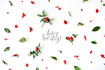 words happy holidays and minimal creative berry arrangement pattern on white. flat lay, top view. christmas background wallpaper.