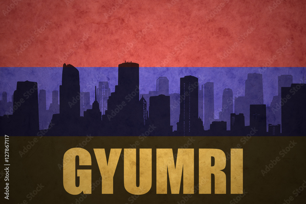 abstract silhouette of the city with text Gyumri at the vintage armenian flag