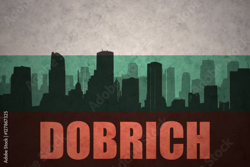 abstract silhouette of the city with text Dobrich at the vintage bulgarian flag