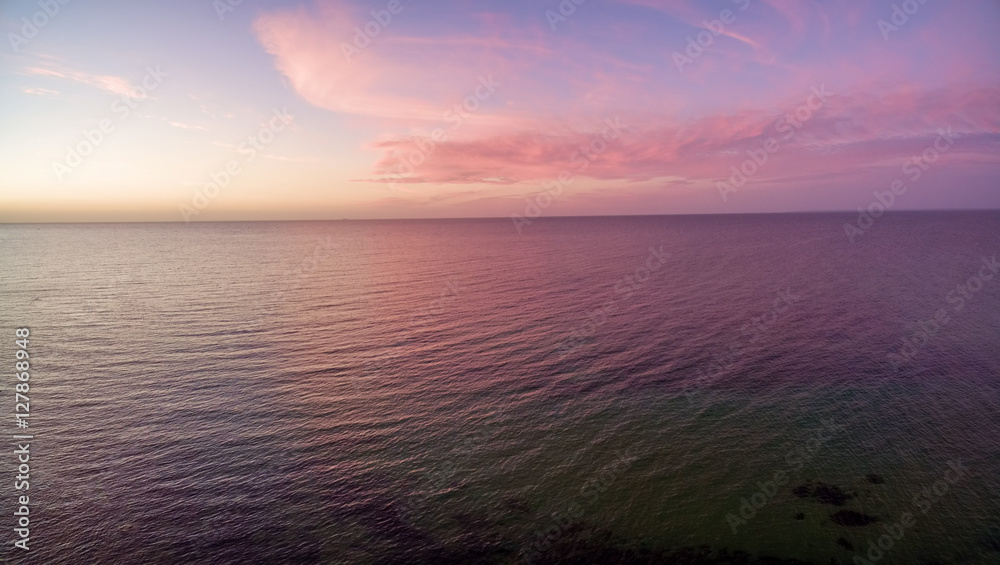 Aerial panorama of sunset over ocean. Nothing but sky, clouds and water. Beautiful serene scene Aerial panorama of sunset over ocean. Nothing but sky, clouds and water. Beautiful serene scene