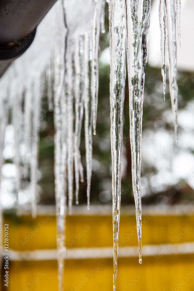 Icicles hang from the roof and dripping them. Spring. Icicles hang from the roof and dripping them. Spring.
