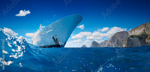 Luxury Yacht on the sea taken from water with mountains in background. Amazing beautiful view.