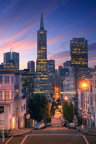 San Francisco downtown at sunrise - night. Famous typical buildings in front. California theme.