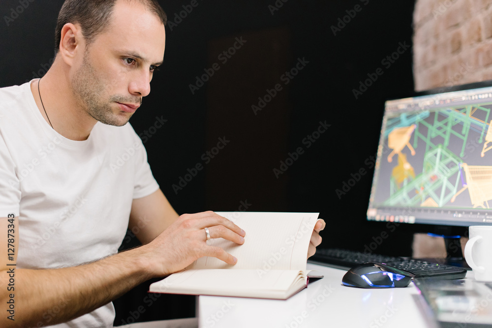 Young man working hard on his project Young man working hard on his project