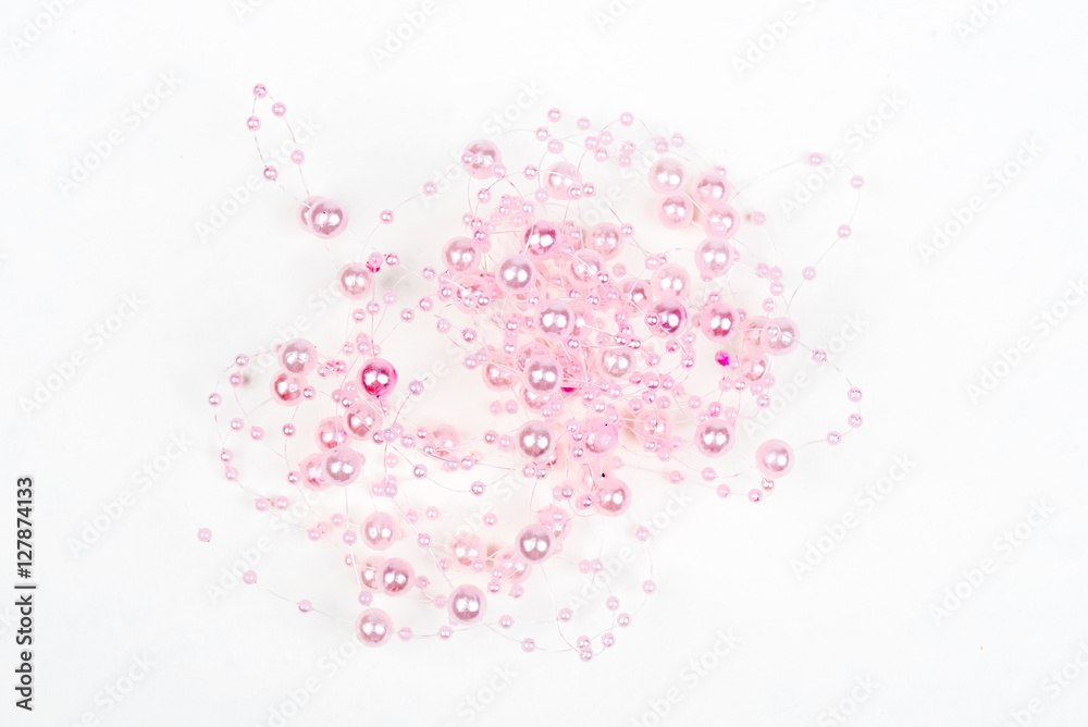Christmas, wedding, vanetine, greeting decoration – big and small pink pearls on the line (string). Pearl decoration isolated on white background. Pink balls.