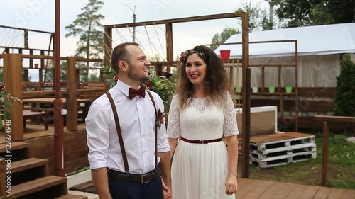 The couple, laughing from happiness and excitement near the wedding altar.